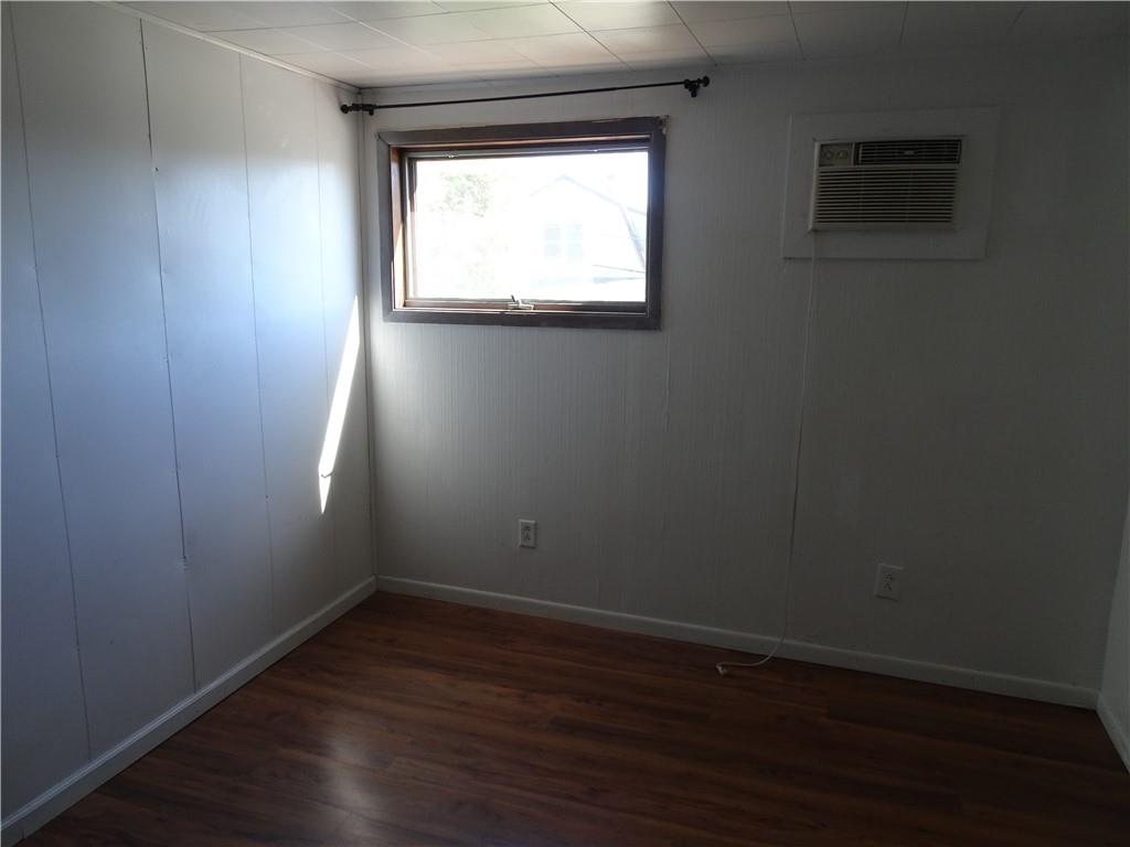 227 South 6th Street Youngwood, PA 15697 - Photo 20 of 27 an empty room with wooden floor and windows