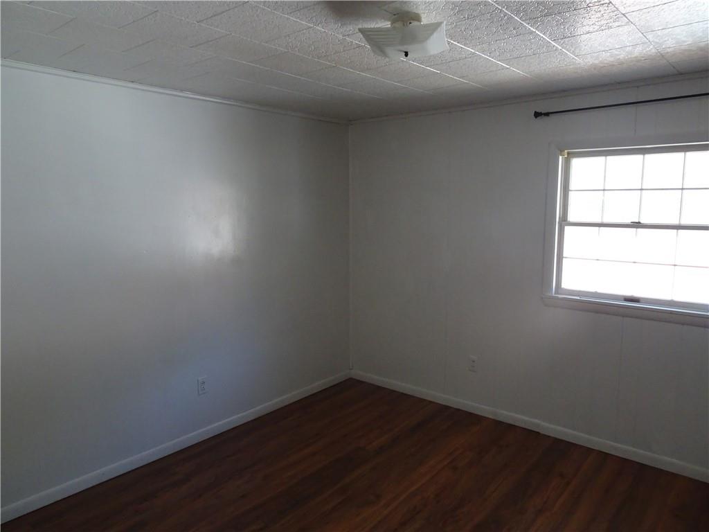 227 South 6th Street Youngwood, PA 15697 - Photo 21 of 27 an empty room with wooden floor and windows