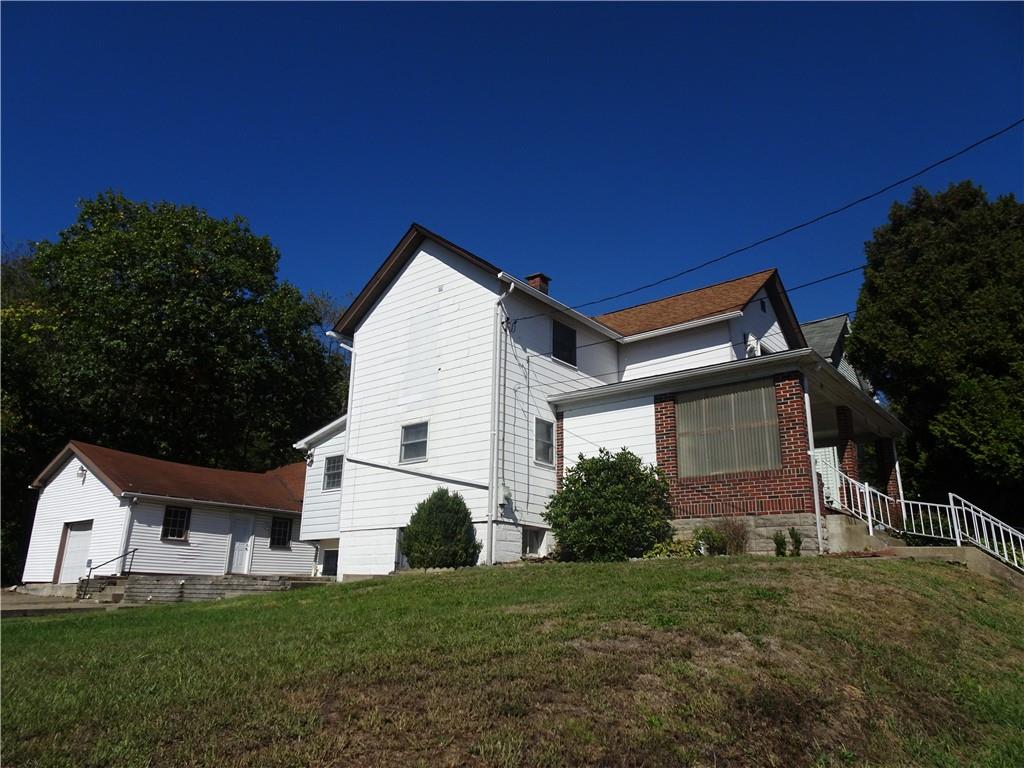 227 South 6th Street Youngwood, PA 15697 - Photo 3 of 27 a front view of a house with a yard and garage