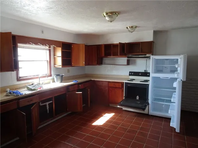 a kitchen with a sink a stove and cabinets