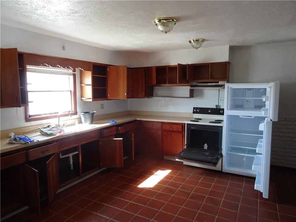 227 South 6th Street Youngwood, PA 15697 - Photo 4 of 27 a kitchen with a sink a stove and cabinets