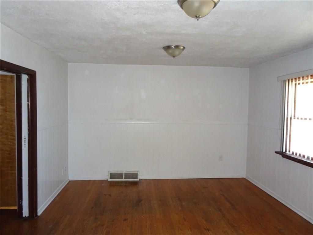 227 South 6th Street Youngwood, PA 15697 - Photo 8 of 27 an empty room with wooden floor and windows
