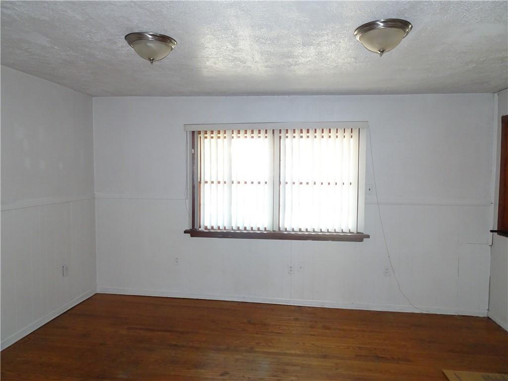 227 South 6th Street Youngwood, PA 15697 - Photo 9 of 27 an empty room with wooden floor and windows