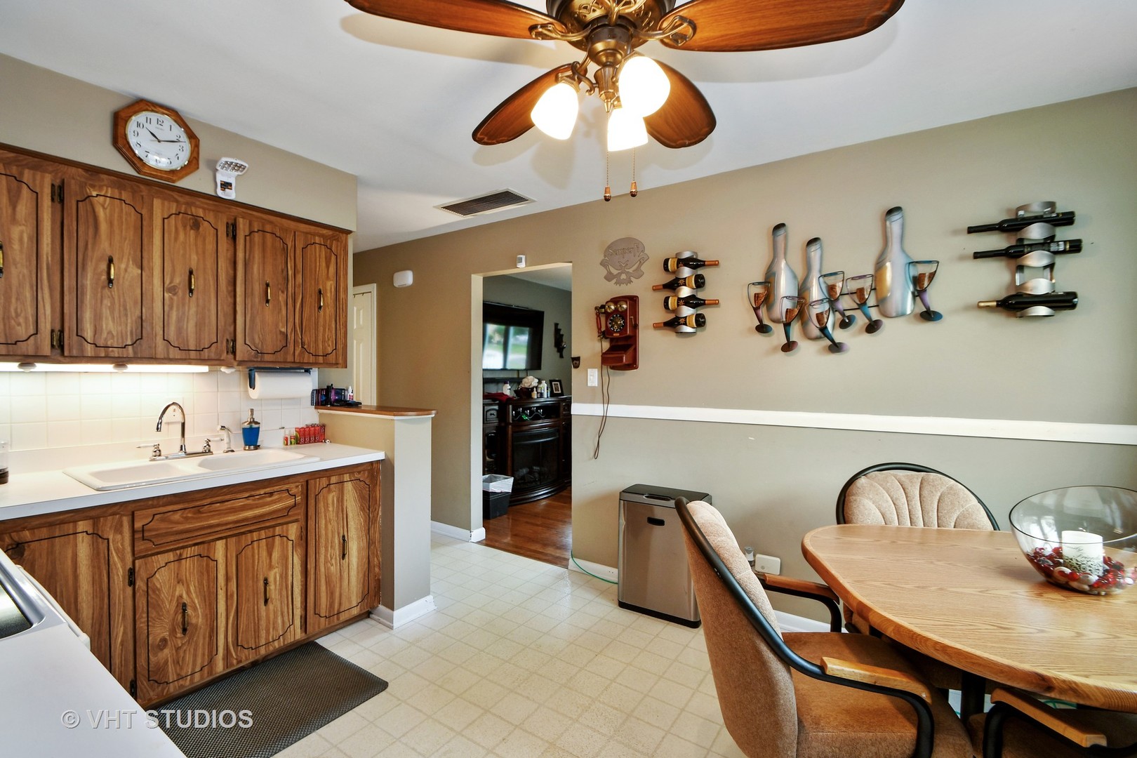 10801 Mayfield Avenue Chicago Ridge, IL 60415 - Photo 4 of 10 a kitchen with a dining table chairs sink and cabinets