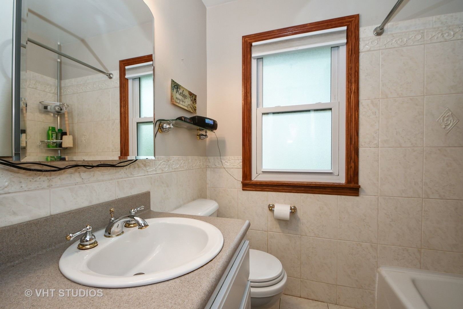 10801 Mayfield Avenue Chicago Ridge, IL 60415 - Photo 7 of 10 a bathroom with a sink a toilet and mirror
