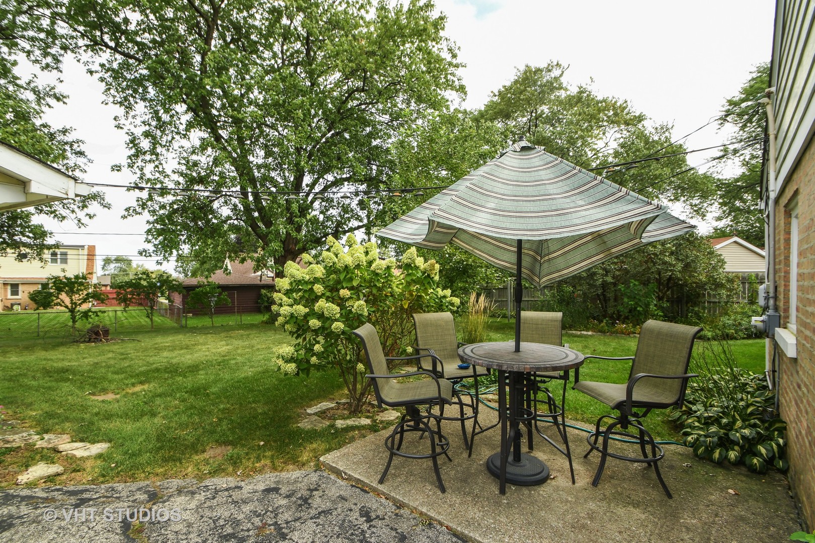 10801 Mayfield Avenue Chicago Ridge, IL 60415 - Photo 8 of 10 a patio with a table and chairs and a barbeque