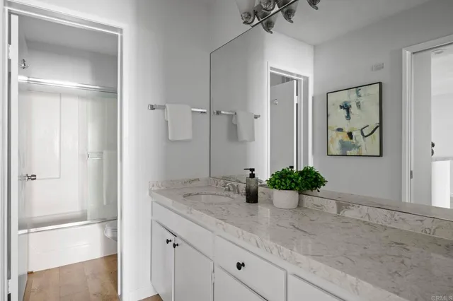 a view of bathroom with a sink and mirror