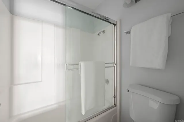 a bathroom with a shower and a toilet