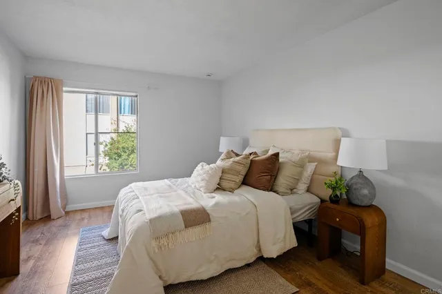 a bed sitting in a bedroom next to a window
