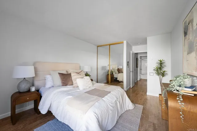 a bedroom with a bed and wooden floor