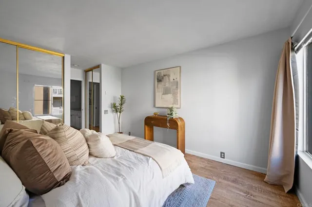 a bedroom with a bed and a large window