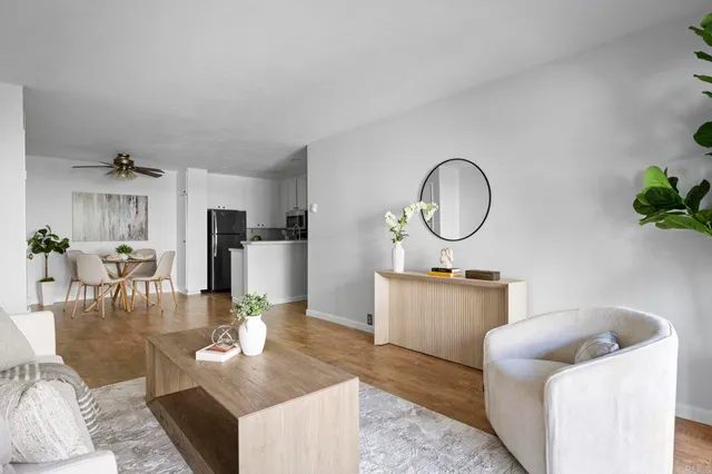 a living room with fireplace furniture and a wooden floor