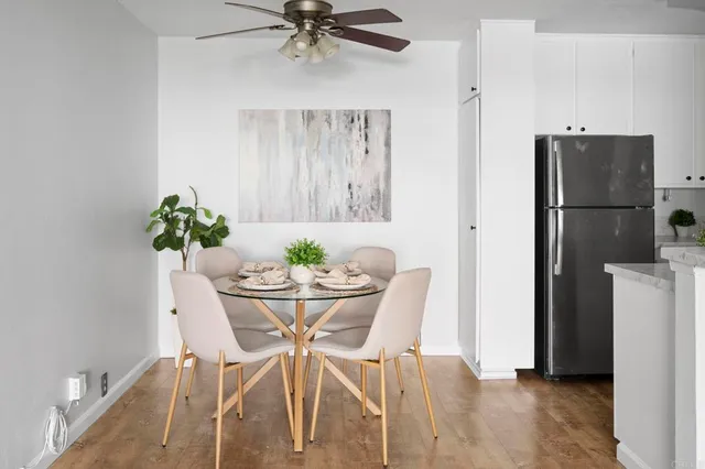 a view of a dining room with furniture and a potted plant