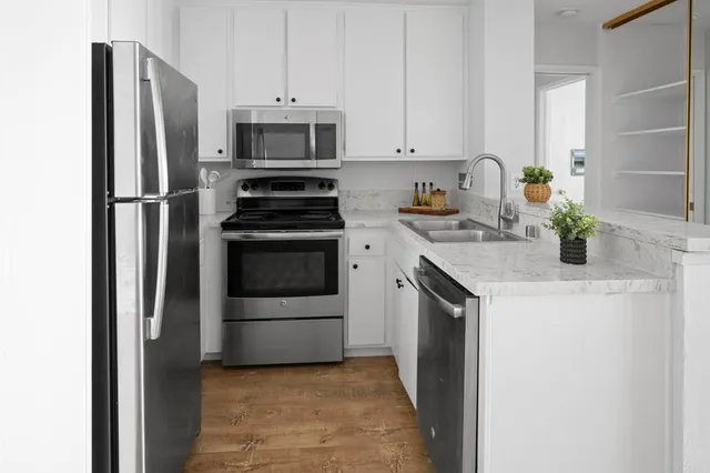 a kitchen with a sink stove and refrigerator