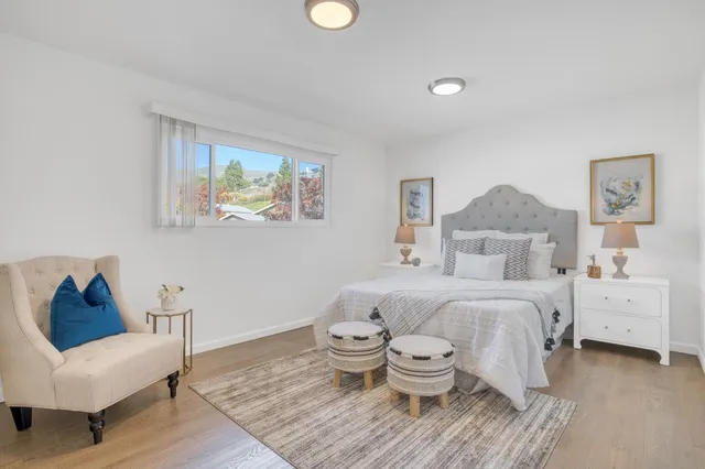 a spacious bedroom with a bed and a couch