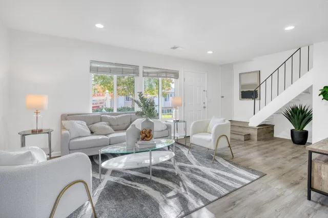 a living room with furniture and a potted plant