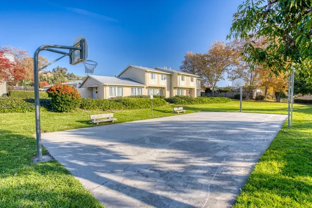 a front view of a house with a yard and trees