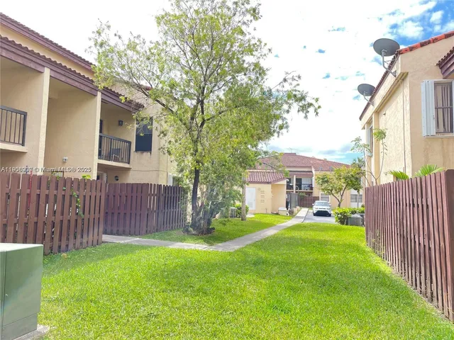 a view of a house with a yard and sitting area