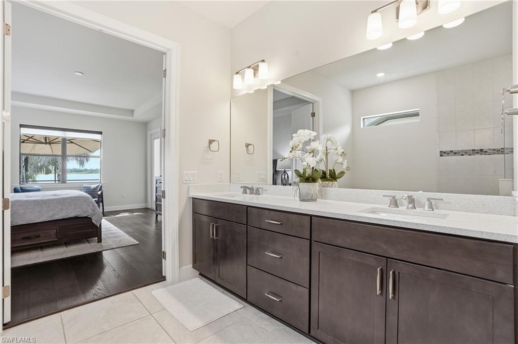 19696 Aqua View Lane Fort Myers, FL 33913 - Photo 19 of 50 a en suite bathroom with a double vanity sink and a mirror