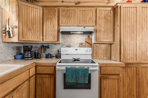 a kitchen with a sink stove and cabinets