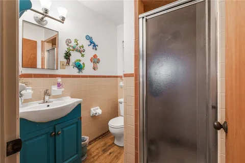 a bathroom with a sink a toilet a vanity and a mirror