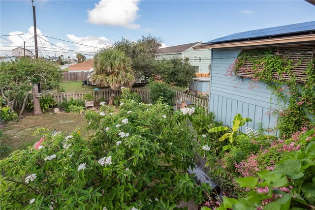 a view of a house with a small yard and plants