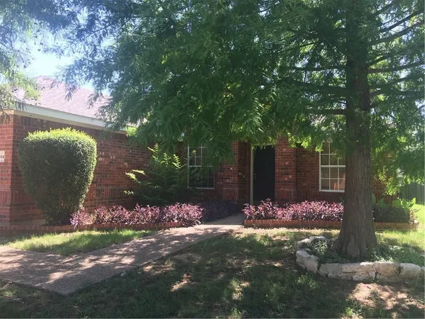 a view of a backyard house with large trees
