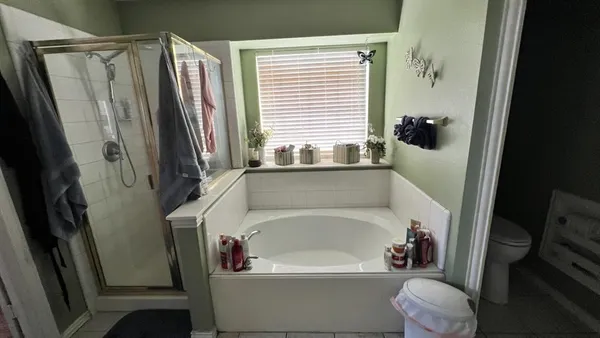 a white bath tub sitting next to a white toilet