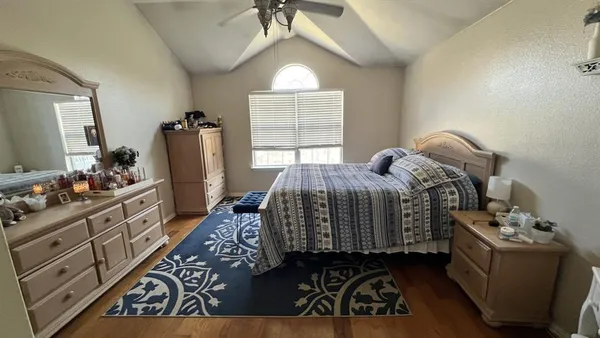 a bedroom with a bed and a dresser in it