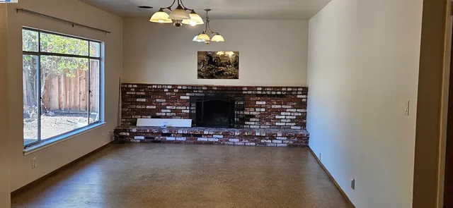 a room with fireplace and wooden floor