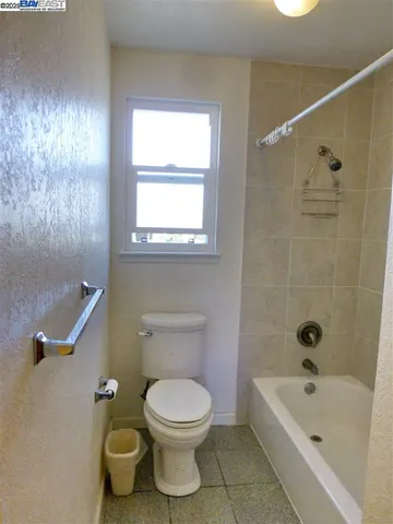 a bathroom with a toilet a sink and bathtub