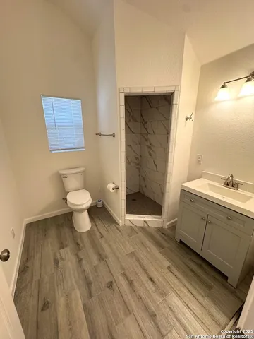 a spacious bathroom with a sink toilet a mirror and vanity