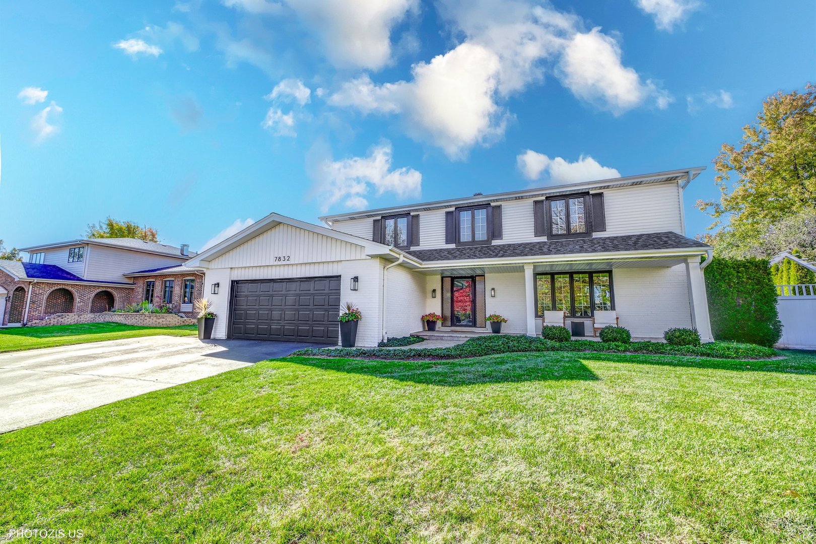 7832 Adams Street Darien, IL 60561 - Photo 2 of 2 a front view of a house with a yard and garage