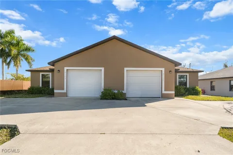 a front view of house with yard and trees