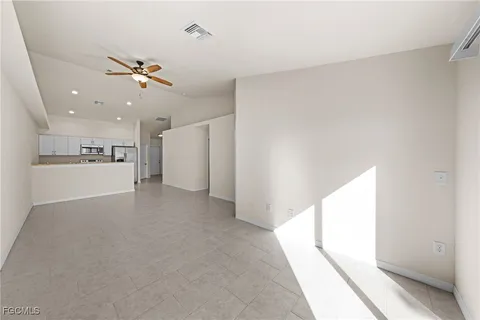 a view of a kitchen with a sink and a refrigerator