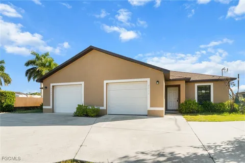 a front view of a house with yard and a garage