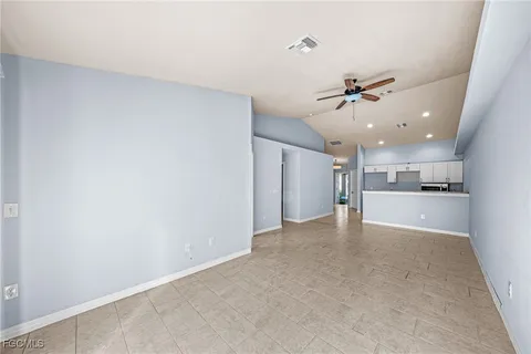 a view of a kitchen with a sink and a refrigerator