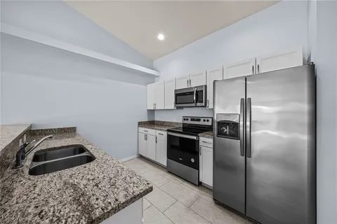 a kitchen with a refrigerator sink and microwave