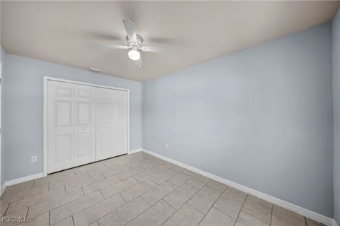 an empty room with a fan