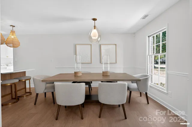 a view of a dining room with furniture window and wooden floor