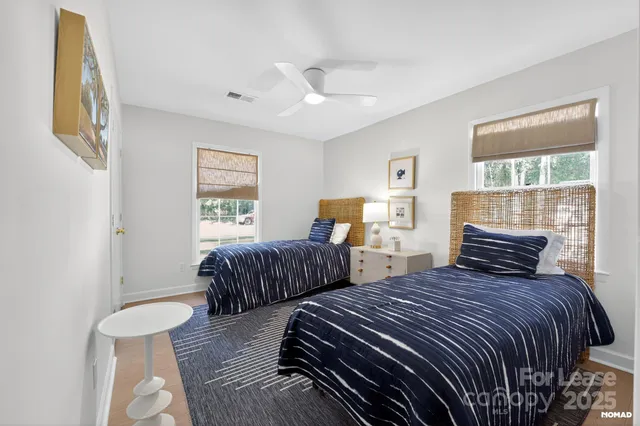 a bedroom with two beds and a large window