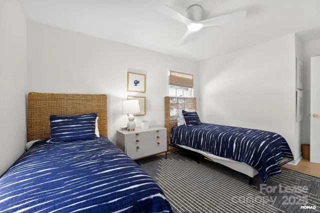 a bedroom with two beds and painting on the wall