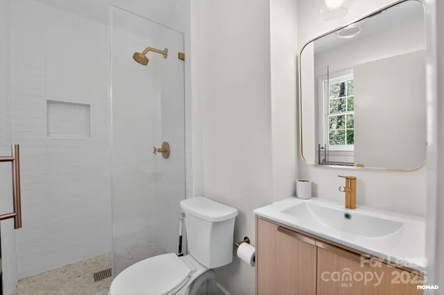a bathroom with a sink toilet and mirror