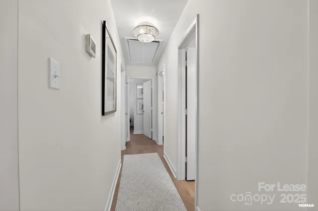 a view of a hallway with wooden floor
