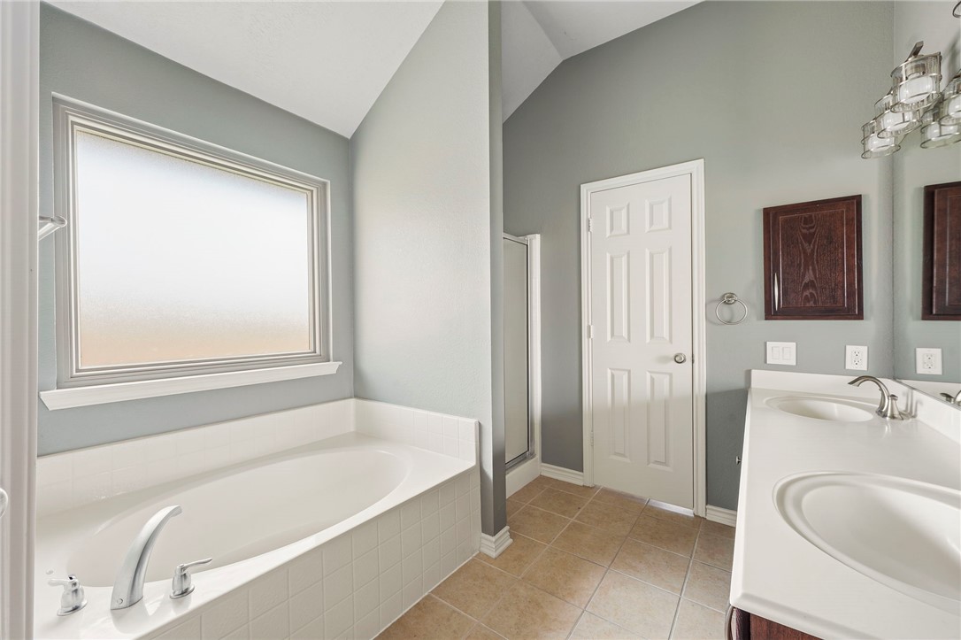 1700 Kingsgate Drive Bryan, TX 77807 - Photo 13 of 21 a bathroom with a tub sink and mirror