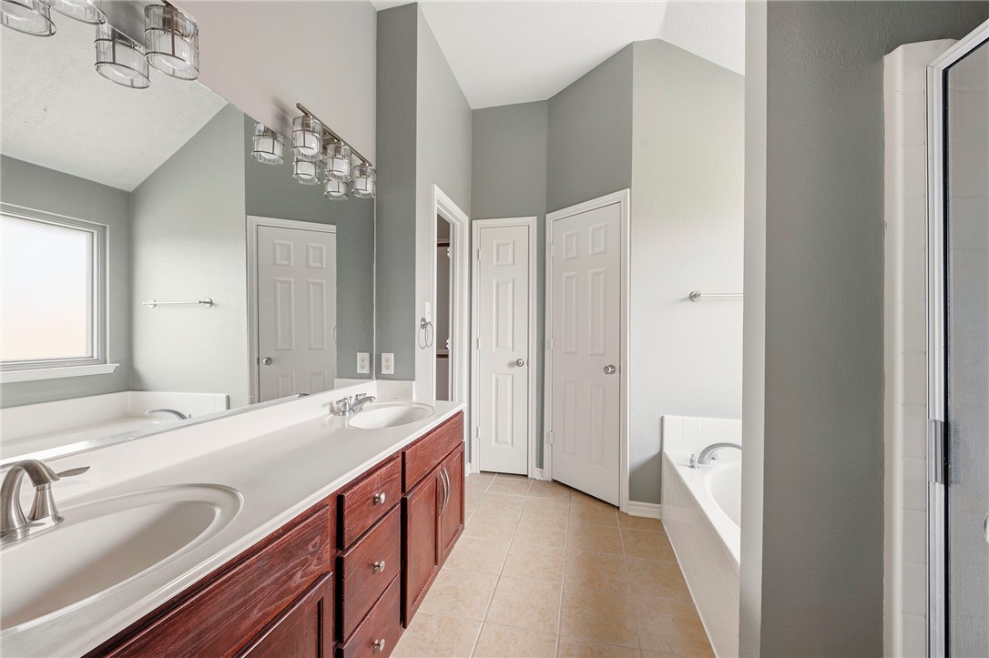 1700 Kingsgate Drive Bryan, TX 77807 - Photo 14 of 21 a bathroom with a sink double vanity and a mirror