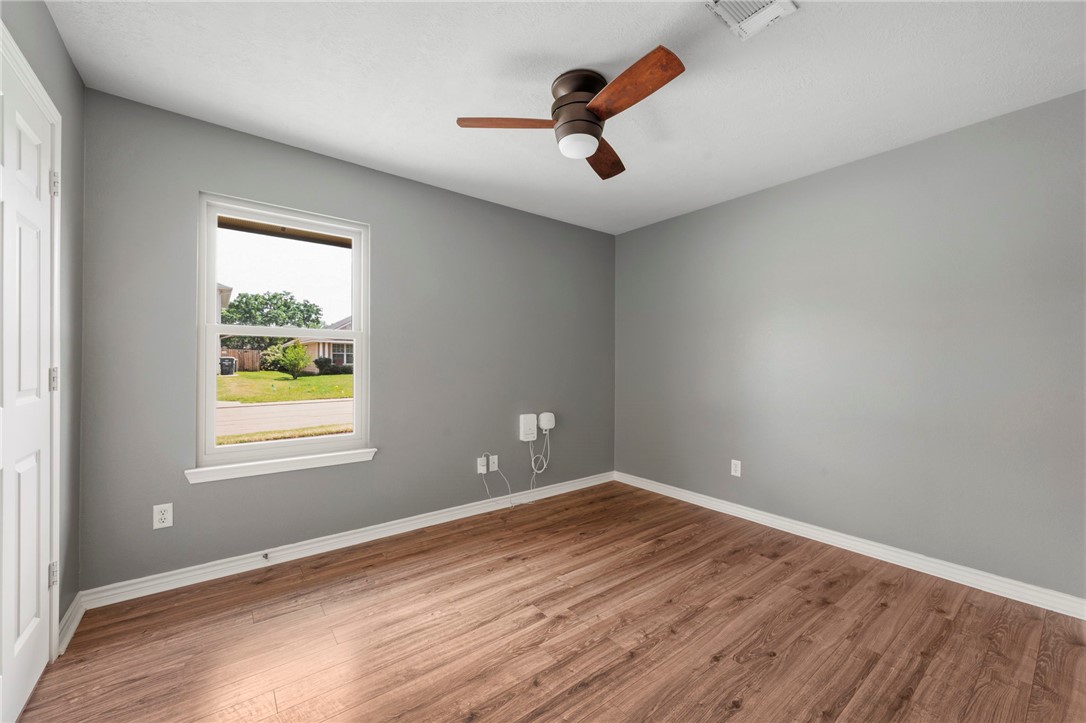 1700 Kingsgate Drive Bryan, TX 77807 - Photo 16 of 21 wooden floor in an empty room with a window