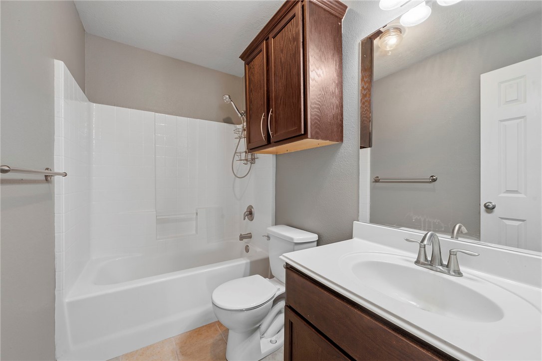 1700 Kingsgate Drive Bryan, TX 77807 - Photo 17 of 21 a bathroom with a sink a toilet and shower