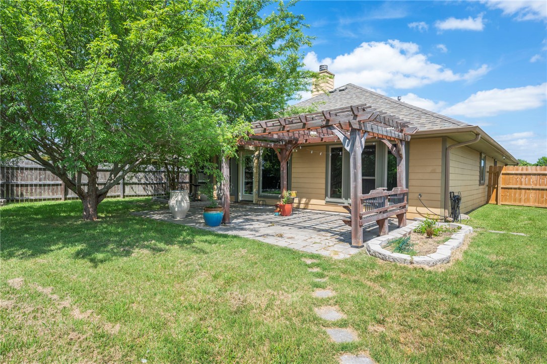 1700 Kingsgate Drive Bryan, TX 77807 - Photo 19 of 21 a view of a chair and table in backyard of the house