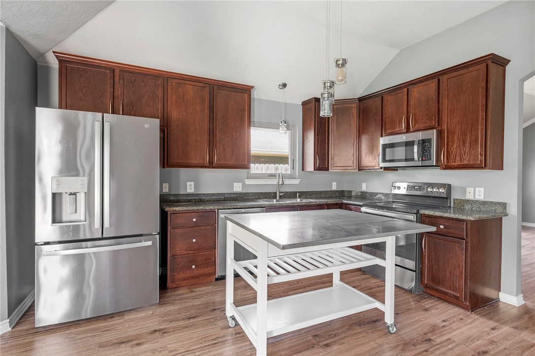 1700 Kingsgate Drive Bryan, TX 77807 - Photo 9 of 21 a kitchen with wooden cabinets and stainless steel appliances